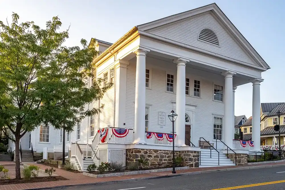 Old Town Hall, a white columned building with patriotic bunting, in Fairfax, Virginia