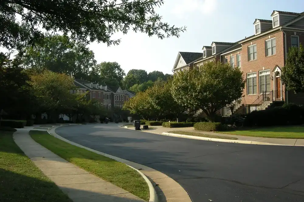 Brick townhouses along a curving tree-lined street in Oakton, Virginia